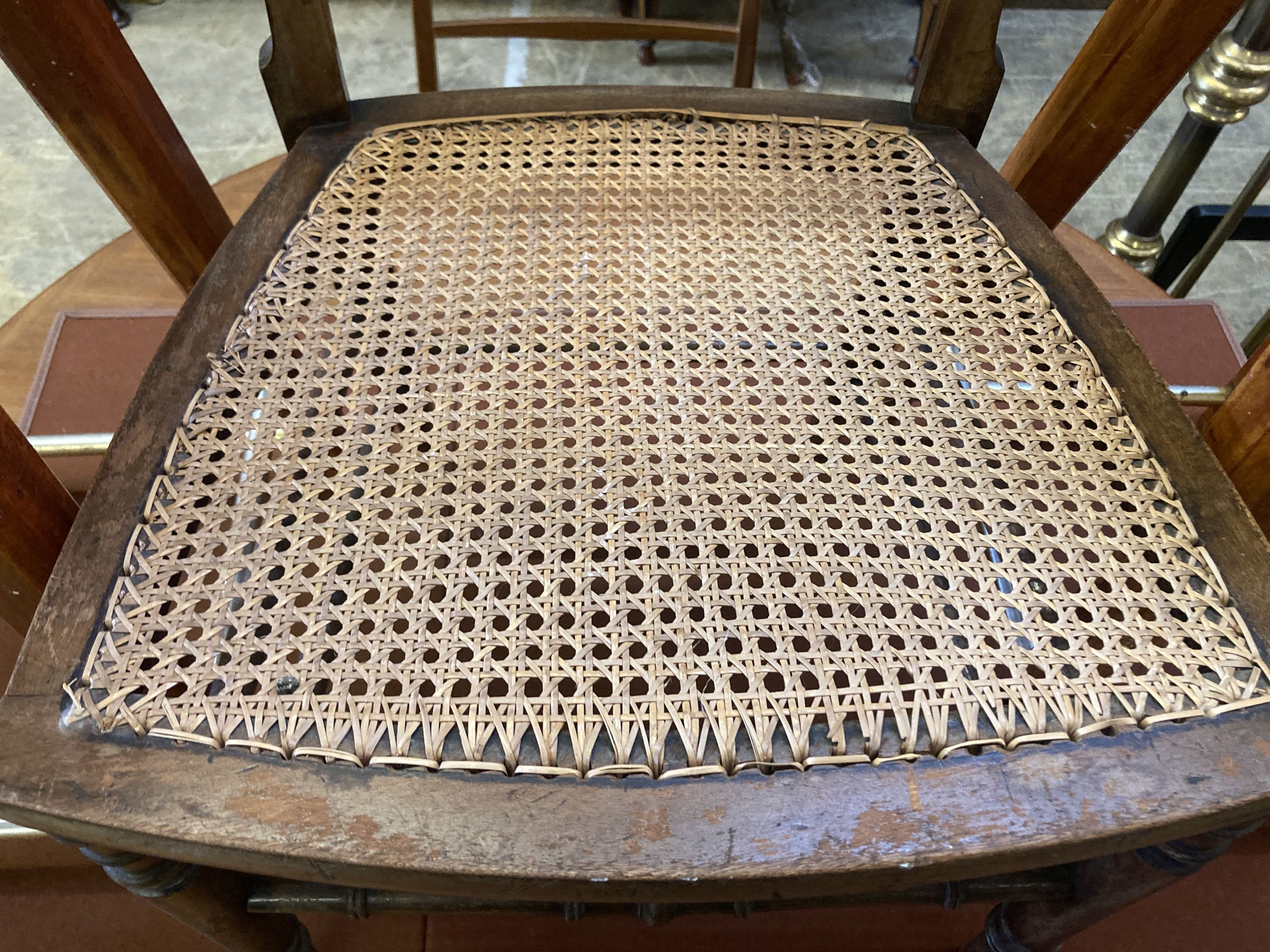 An Edwardian cane seat chair and a pair of beech stools